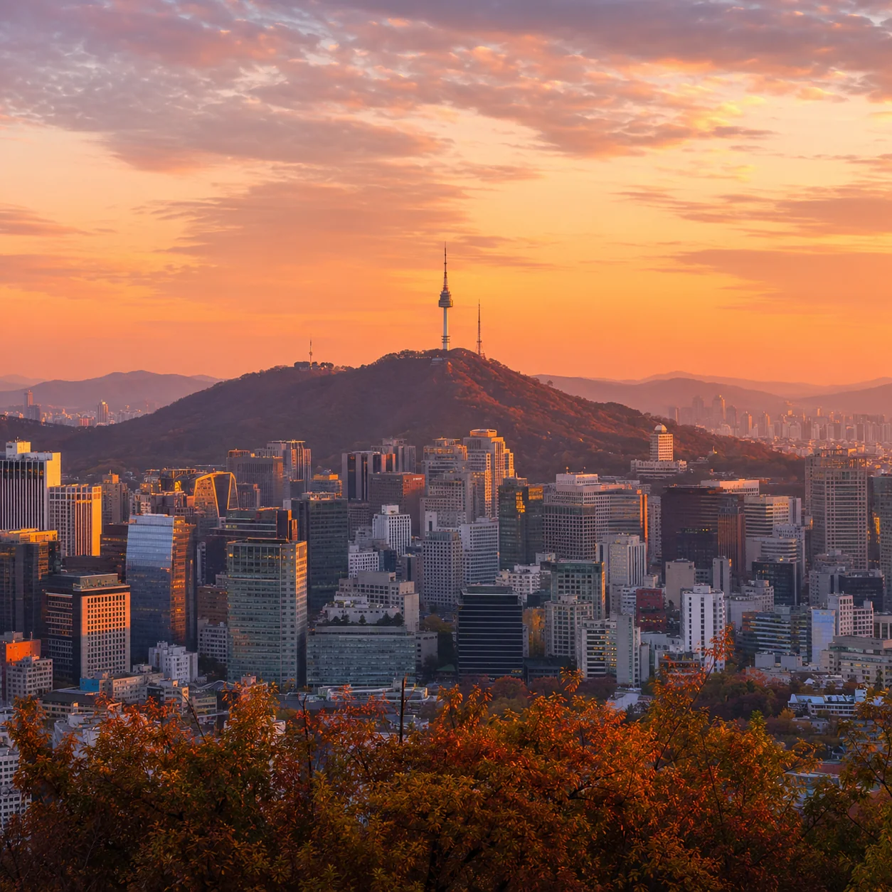 N Seoul Tower on Namsan mountain above the Seoul skyline at golden hour.